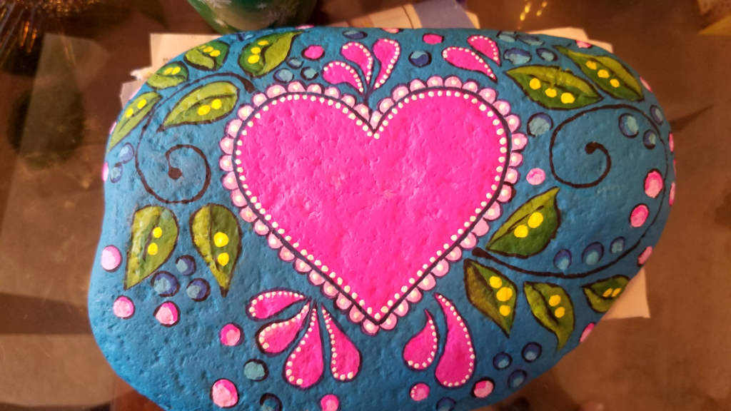 Heart and leaf painted rock