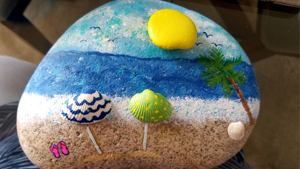 beach scene painted rock with shells